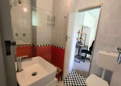 Unit 1 - bathroom and entrance to room 2