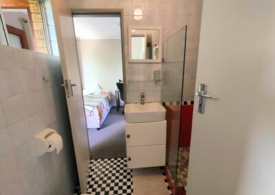 Unit 1 - bathroom and view to room 1